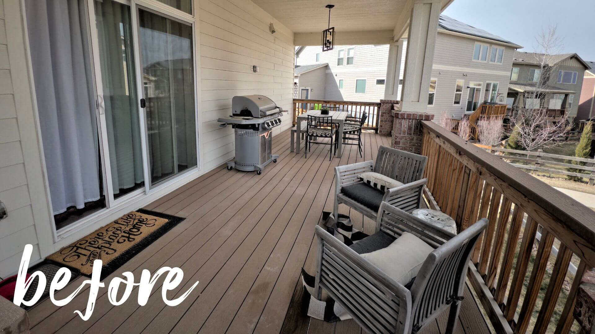a patio with a grill and chairs