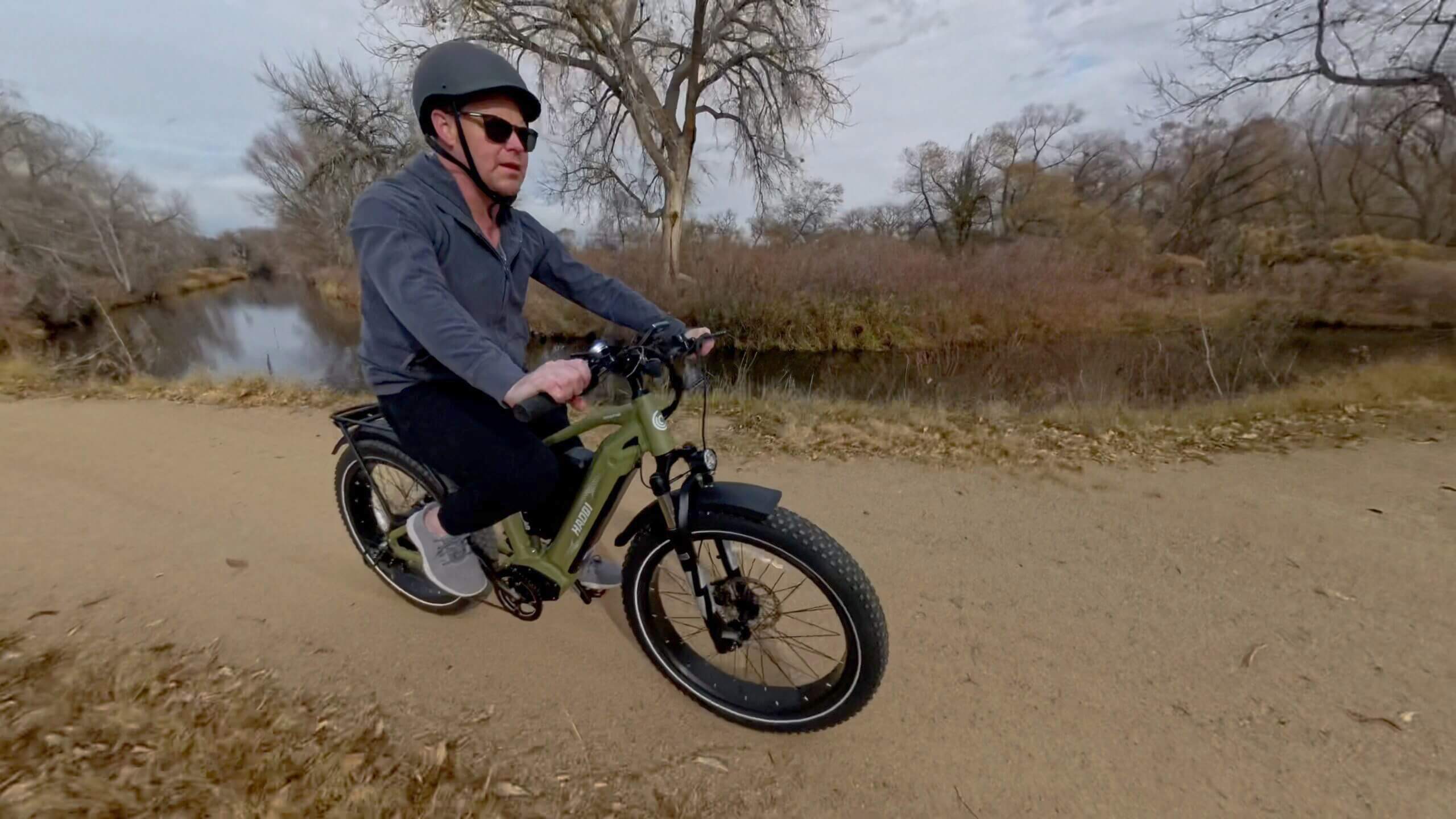 Person riding electric bike on trail.